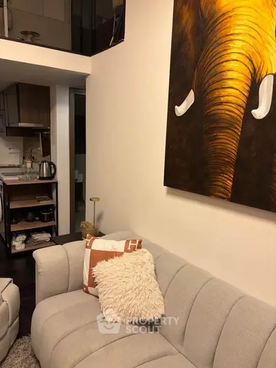 Modern living room with stylish decor and open kitchen layout in a cozy apartment.