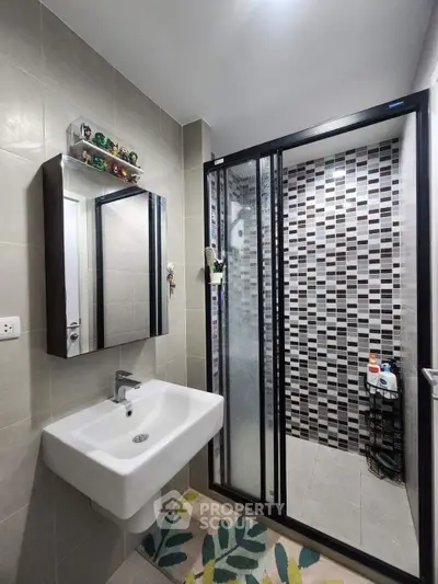 Modern bathroom with sleek sink and stylish shower enclosure
