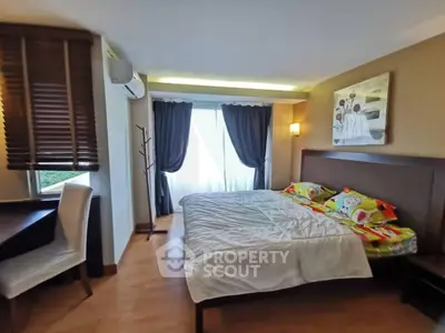 Cozy bedroom with modern decor and natural light, featuring a comfortable bed and stylish furnishings.