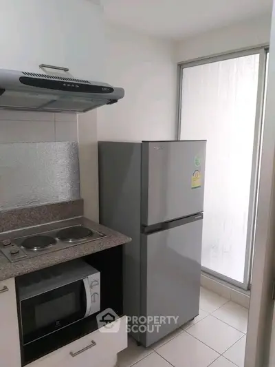 Compact kitchen with modern appliances and sleek design