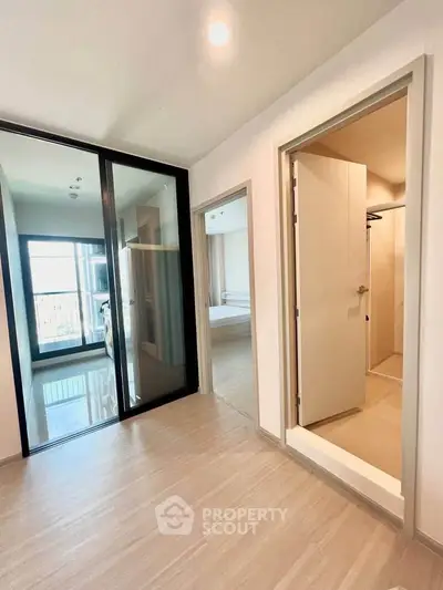 Modern apartment interior with spacious bedroom and sleek sliding glass doors