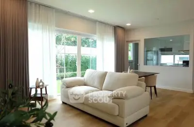 Spacious living room with modern decor and garden view