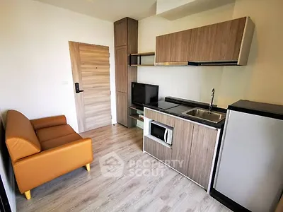 Modern compact living room with kitchenette and stylish wood finishes