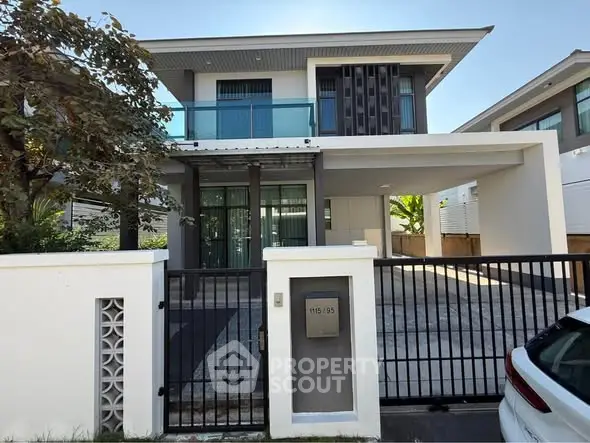 Modern two-story house with sleek design and spacious driveway in a serene neighborhood.