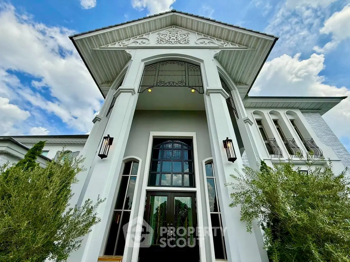 Stunning luxury home exterior with grand entrance and elegant architectural details.