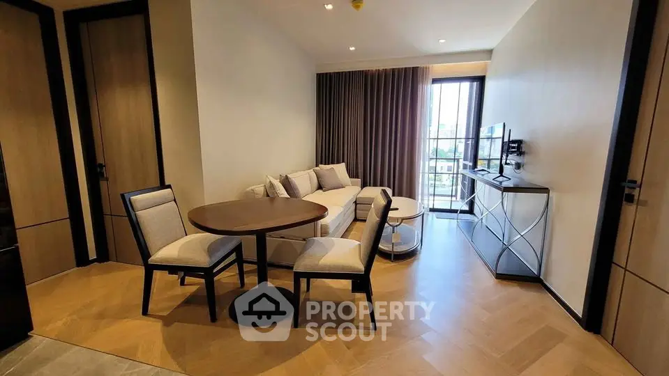 Modern living room with elegant furniture and large window offering city view