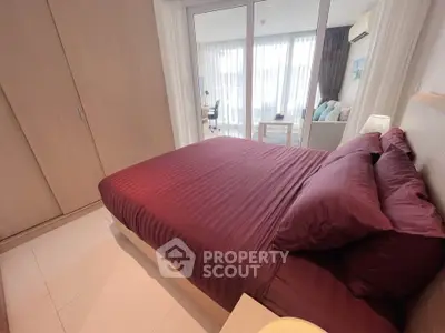 Modern bedroom with elegant decor and balcony access