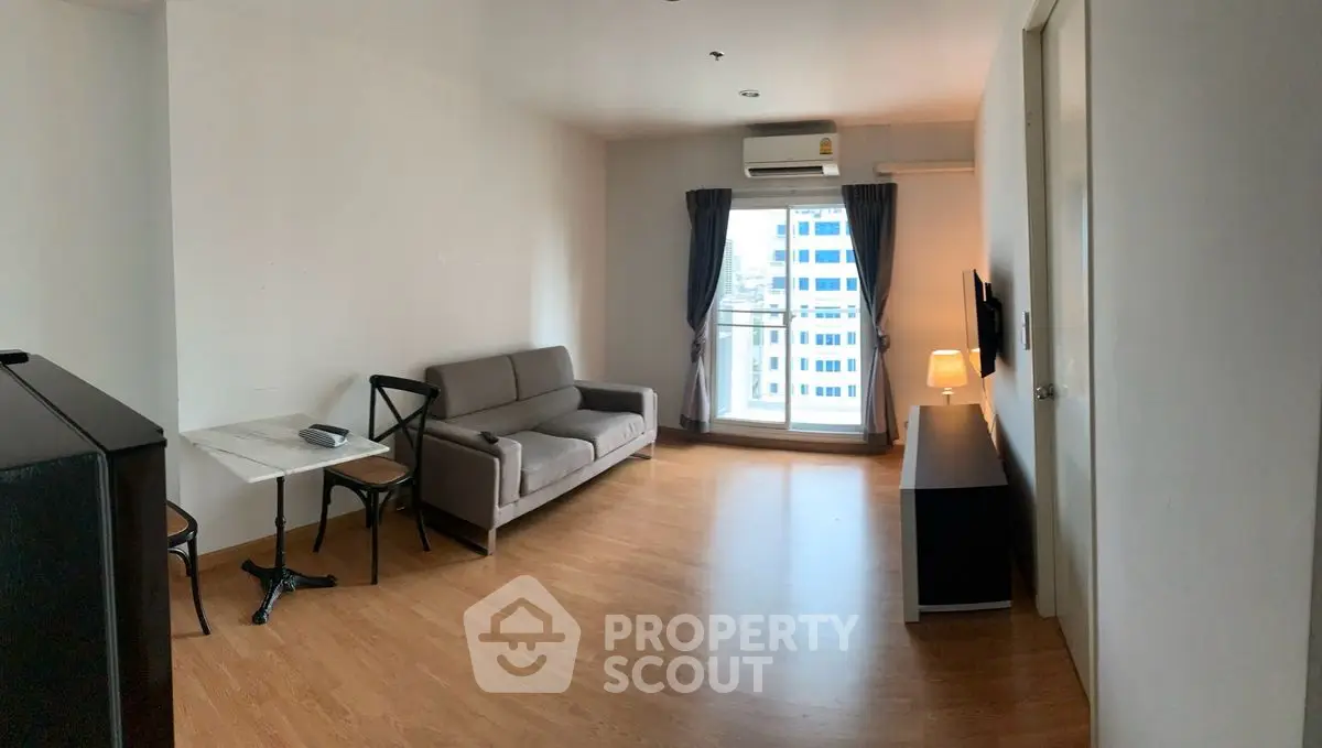 Spacious living room with modern furniture and city view window