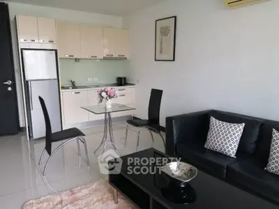Modern open-layout living room with sleek kitchen and stylish furniture