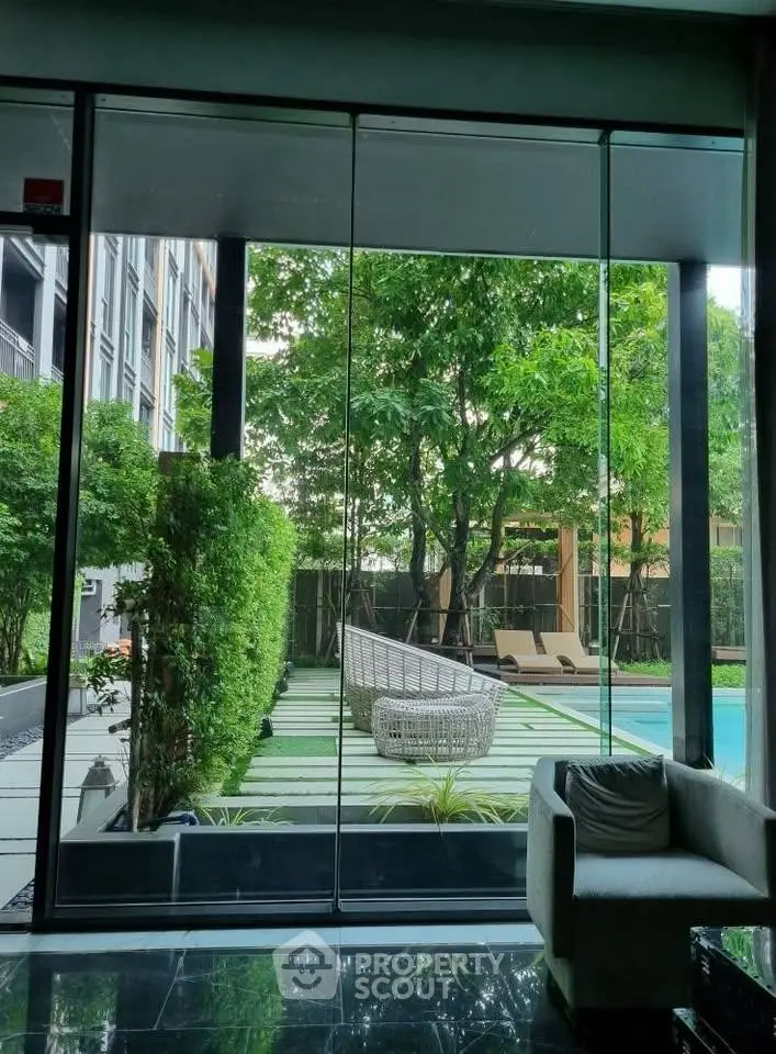 Luxurious poolside view with lush greenery and modern seating area