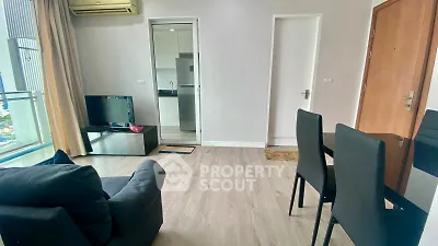 Modern living room with sleek furniture and open kitchen view in a stylish apartment.