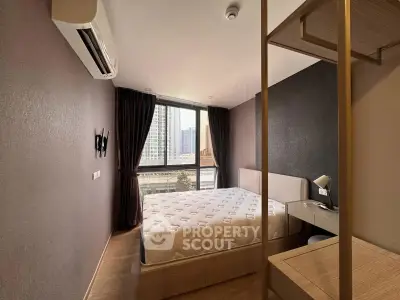 Modern bedroom with city view, featuring a comfortable bed, air conditioning, and stylish decor.
