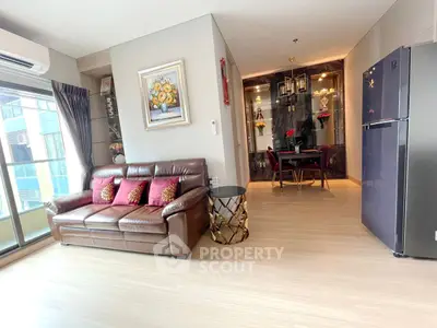 Modern living room with leather sofa and dining area in open layout apartment