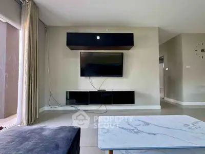 Modern living room with sleek TV setup and marble coffee table