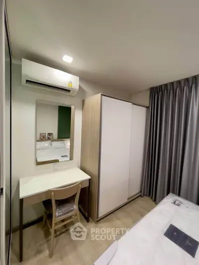 Modern bedroom with sleek wardrobe and cozy workspace