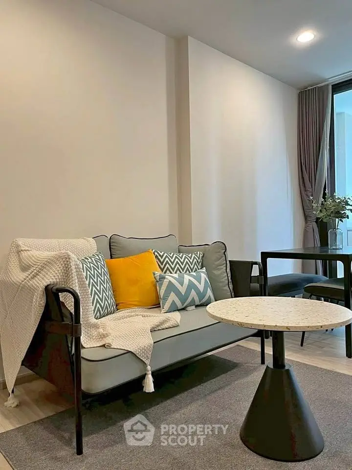 Stylish modern living room with cozy sofa and chic decor in a contemporary apartment.