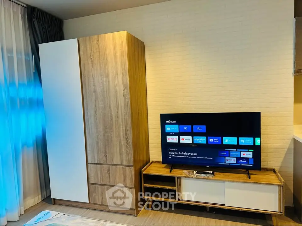 Modern living room with stylish wooden furniture and smart TV setup.