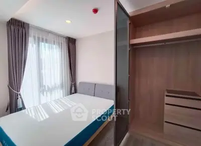 Modern bedroom with natural light and built-in wardrobe, perfect for cozy living.