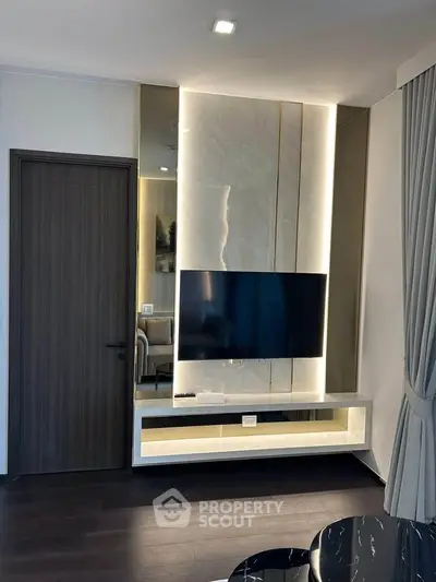 Modern living room with sleek TV wall unit and elegant lighting