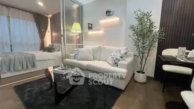 Modern living room with cozy sofa and stylish decor adjacent to a bedroom