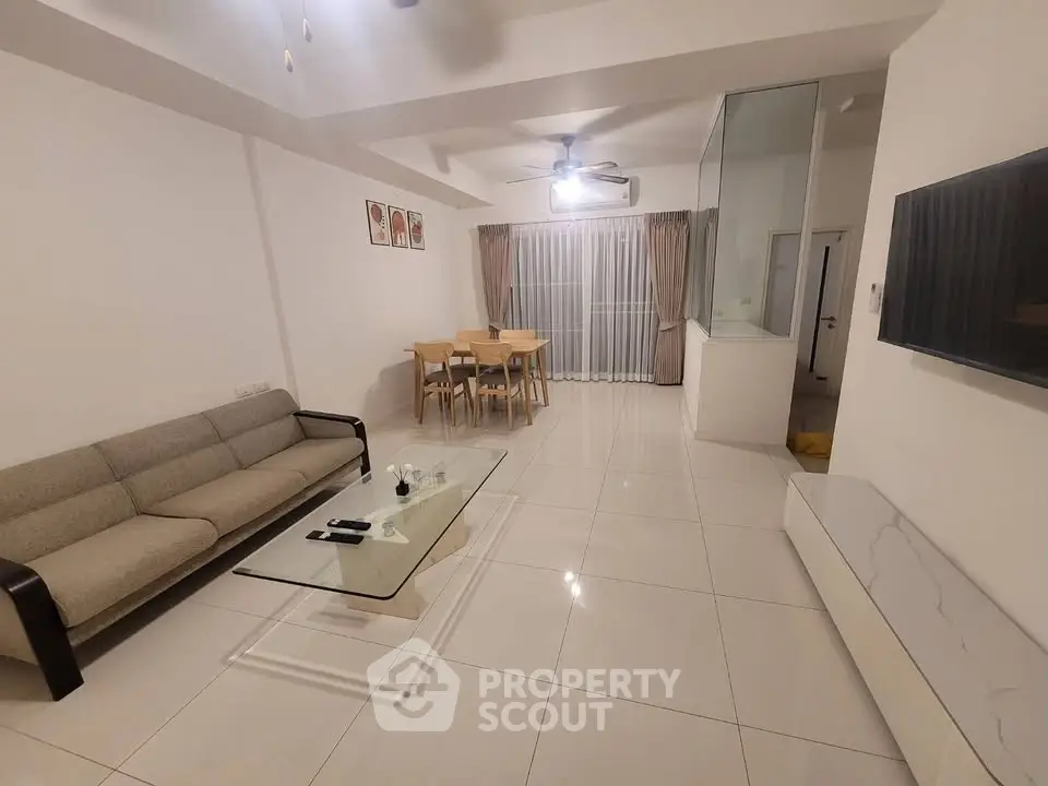 Spacious modern living room with elegant furniture and large windows for natural light.