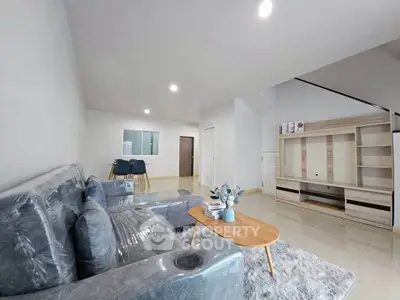 Spacious modern living room with plush sofa and sleek entertainment unit