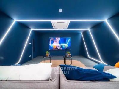 Modern home theater with sleek blue walls and ambient lighting