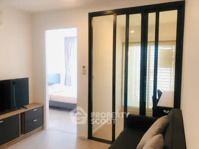 Modern apartment interior with sliding glass doors and cozy living area