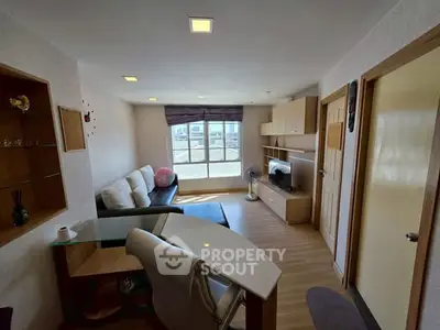 Cozy living room with modern furnishings and large window view