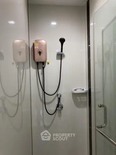 Modern bathroom with glass shower enclosure and water heater
