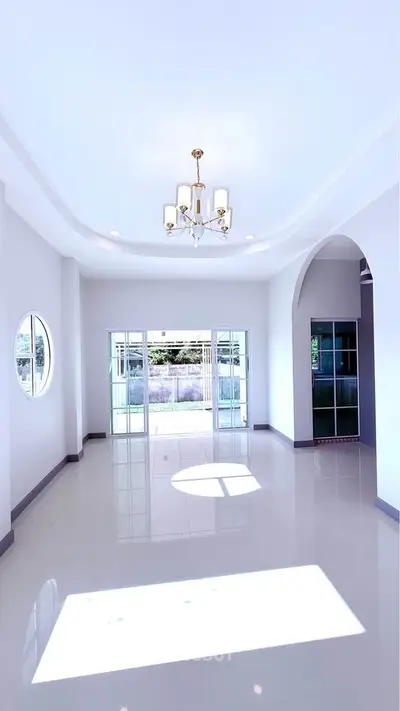 Spacious modern living room with elegant chandelier and large windows