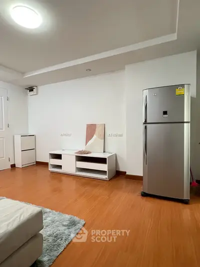 Modern living room with sleek fridge and minimalist decor