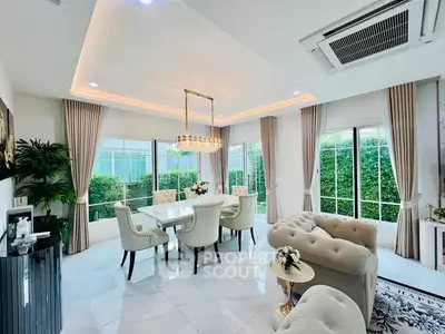 Luxurious living room with elegant dining area, plush seating, and large windows overlooking a lush garden.