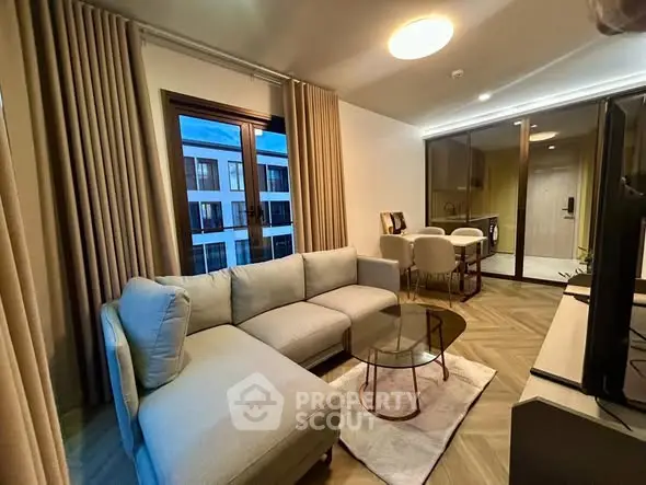 Modern living room with elegant decor and large windows offering a serene view.