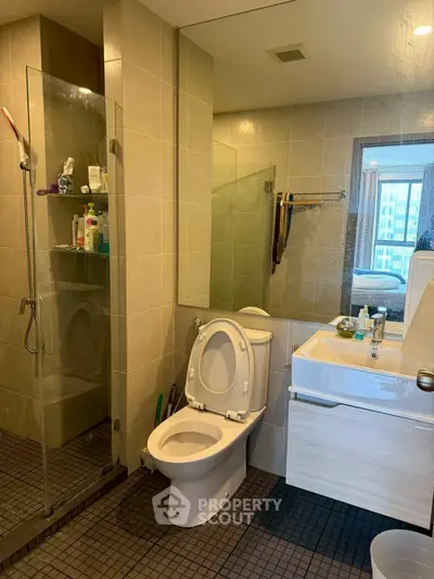 Modern bathroom with glass shower and sleek fixtures in a contemporary apartment.