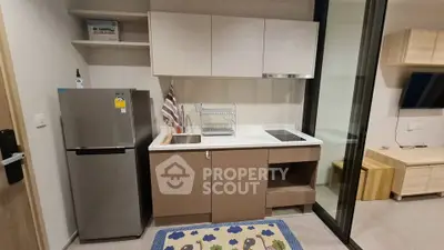 Modern kitchen with sleek cabinetry and compact design in a stylish apartment.