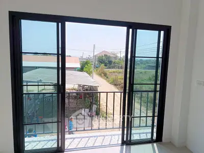 Bright balcony view with sliding glass doors overlooking a serene landscape.