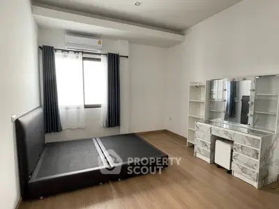 Spacious bedroom with modern decor and ample natural light