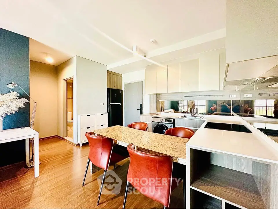 Modern kitchen with sleek design and stylish dining area in luxury apartment