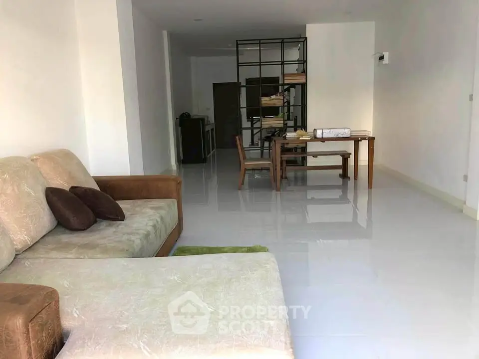 Spacious living room with modern furniture and open layout, perfect for relaxation and entertaining.