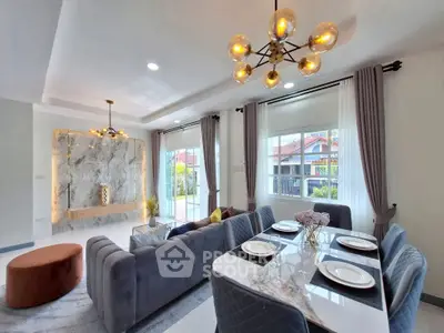 Luxurious modern living room with elegant dining area and stylish lighting fixtures.