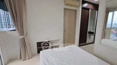 Modern bedroom with city view, featuring a cozy bed, built-in wardrobe, and air conditioning.
