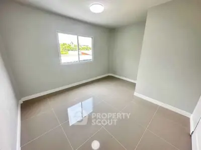 Spacious empty room with large window and glossy tiled floor, perfect for customization.