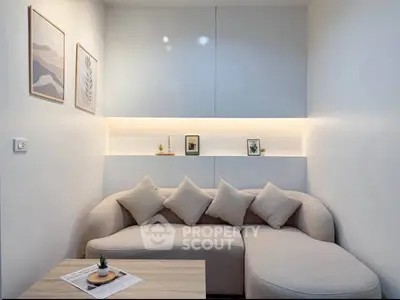 Modern living room with stylish sofa and minimalist decor, perfect for cozy relaxation.