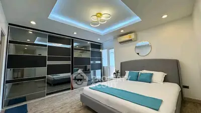 Luxurious bedroom with modern design, featuring a stylish bed, mirrored wardrobe, and elegant ceiling lighting.