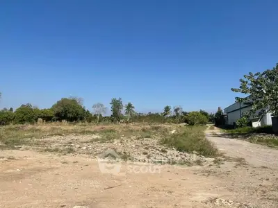 Expansive vacant land with clear blue sky, ideal for development opportunities.