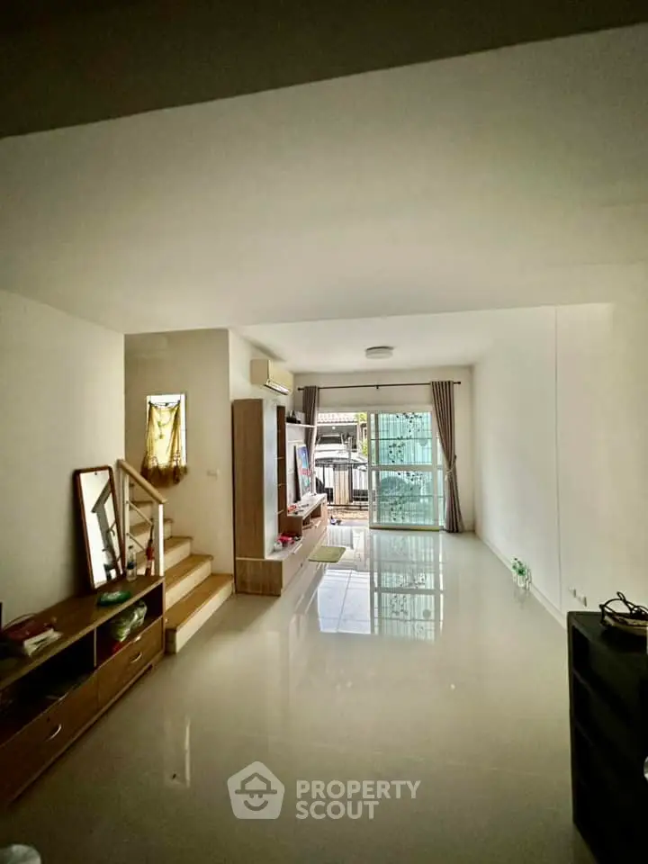 Spacious living room with modern design and large windows offering natural light.