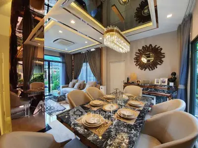 Luxurious dining and living area with elegant decor and chandelier