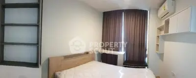 Cozy bedroom with modern shelving and air conditioning, featuring a comfortable bed and stylish curtains.