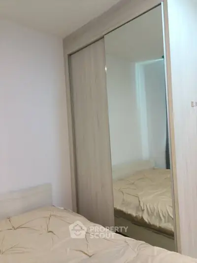 Cozy bedroom with mirrored wardrobe and soft lighting